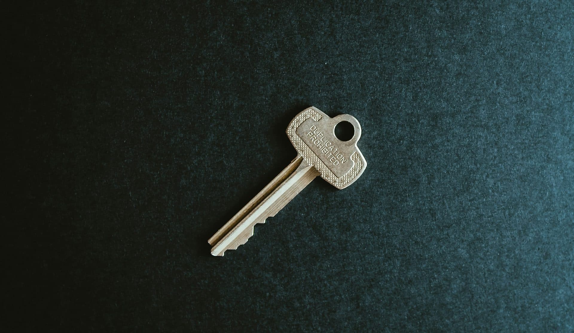 Key on dark velvet as a symbol of trust and privacy