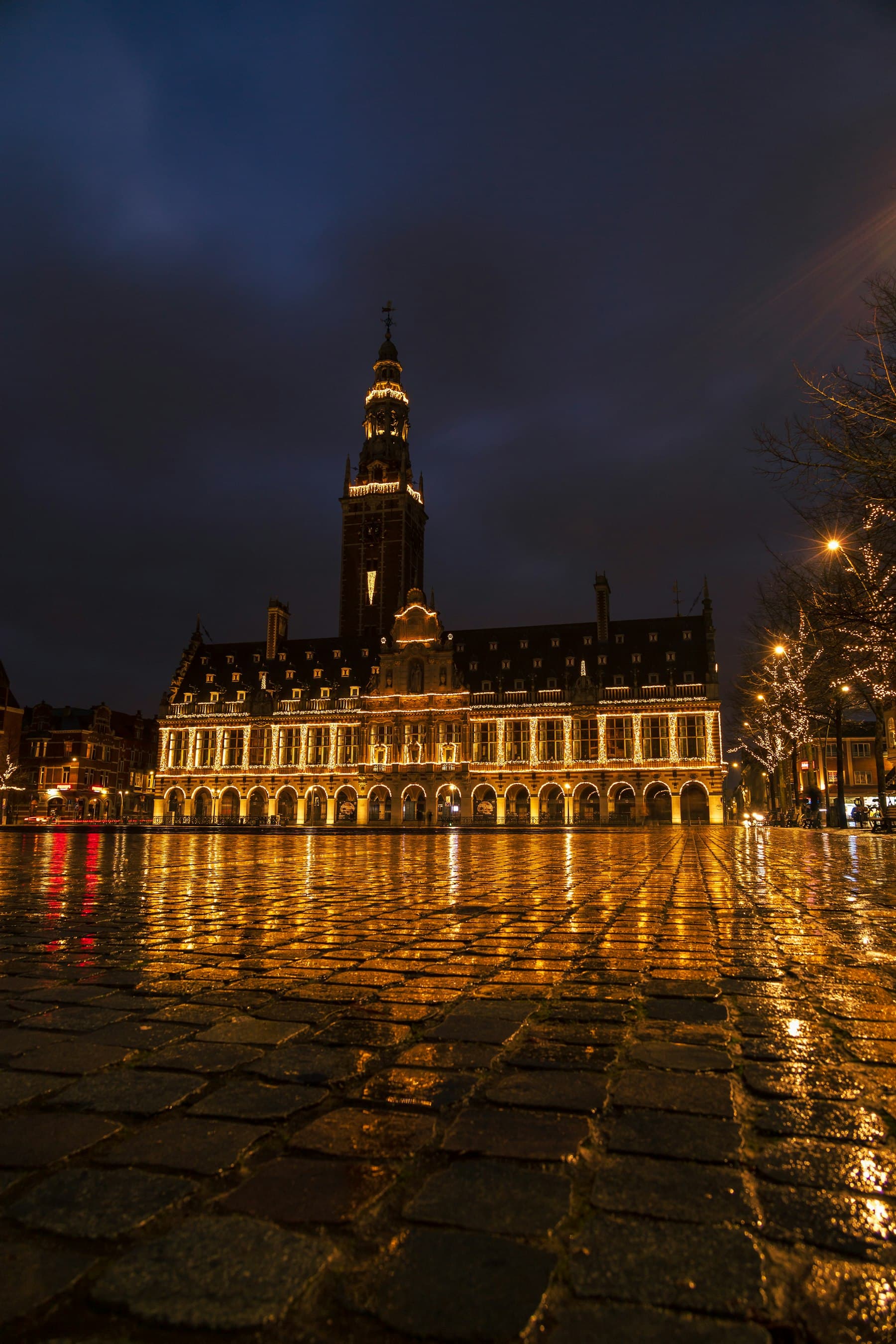 The illuminated University Library on Ladeuzeplein in Leuven in the evening